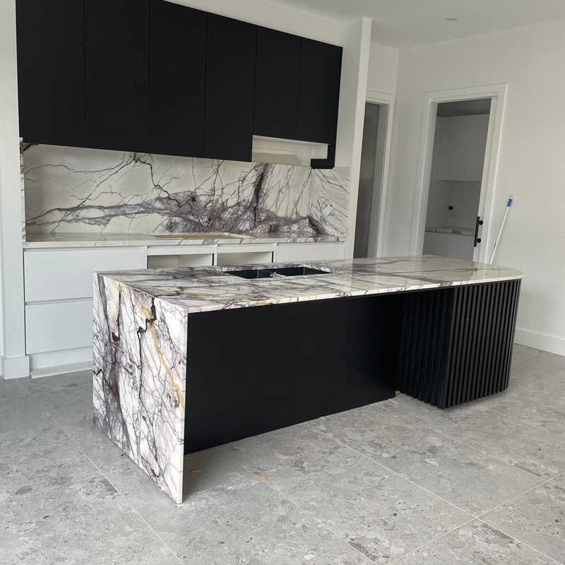 Island with purple-veined marble waterfall ends and a matching splashback