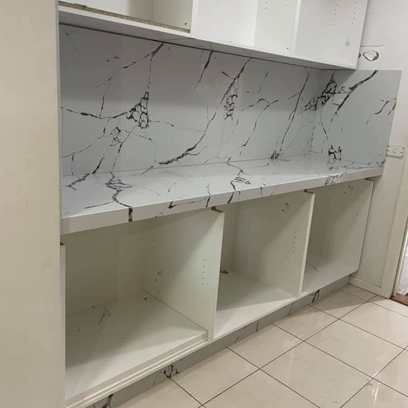 Front view of a white benchtop and full-height splashback with dark veining