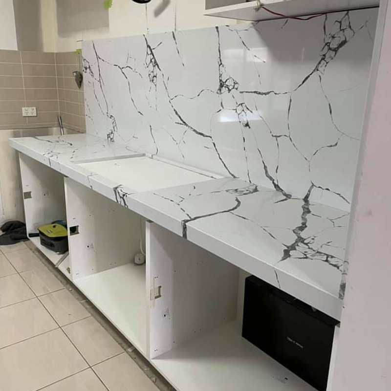 White benchtop and splashback with bold dark veining over open cabinets